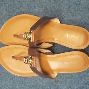 Michael Kors t-strap sandals in brown and tan.